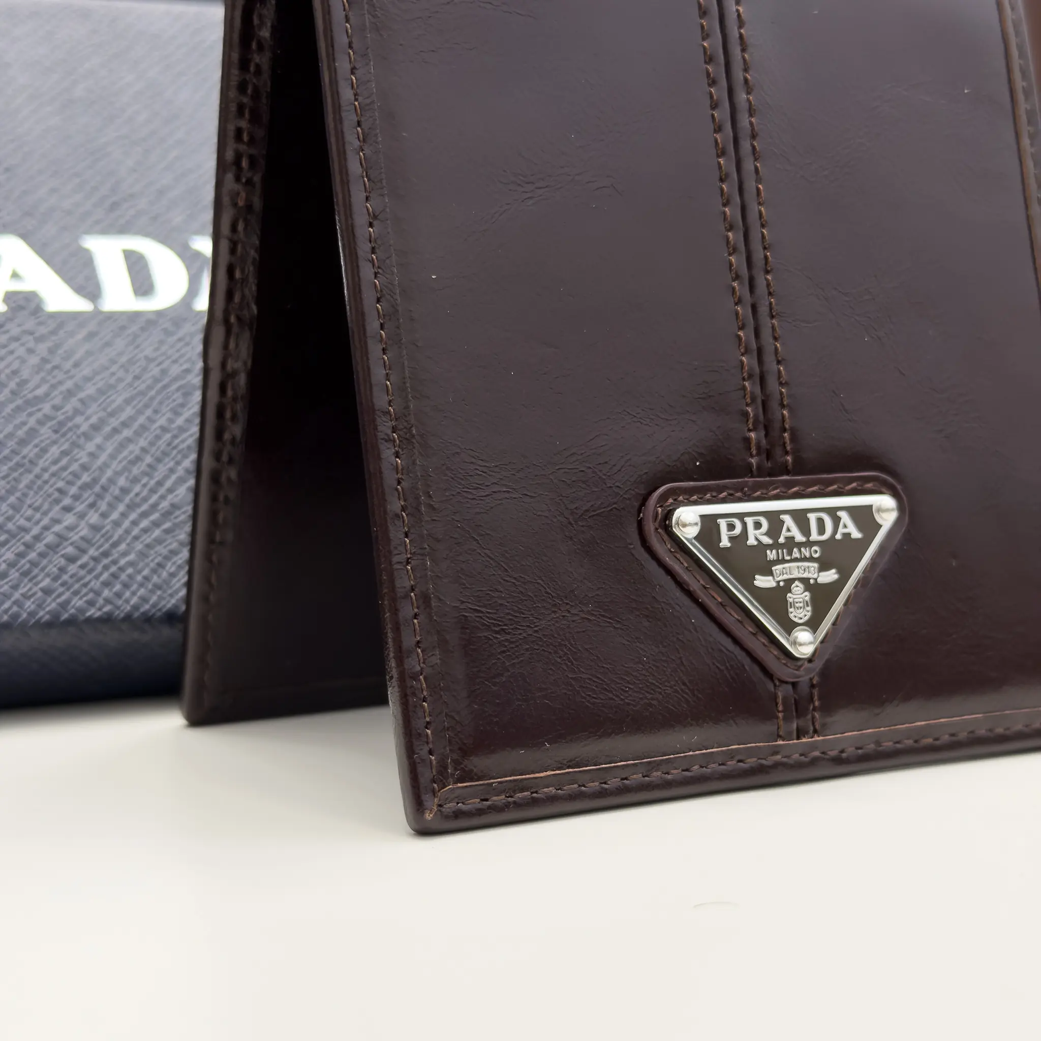 Prada dark brown calfskin bifold wallet with enameled triangle logo