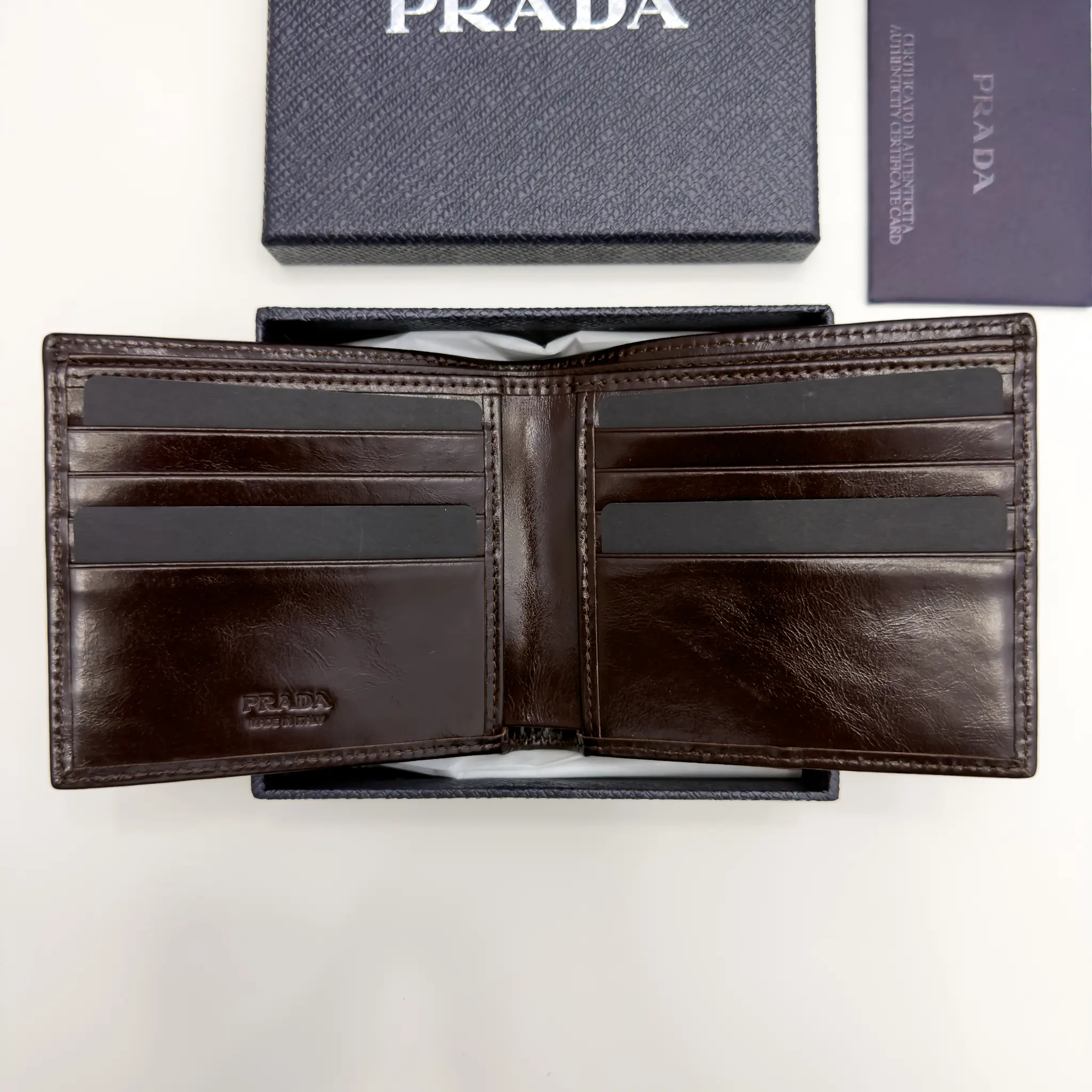 Prada dark brown calfskin bifold wallet with enameled triangle logo