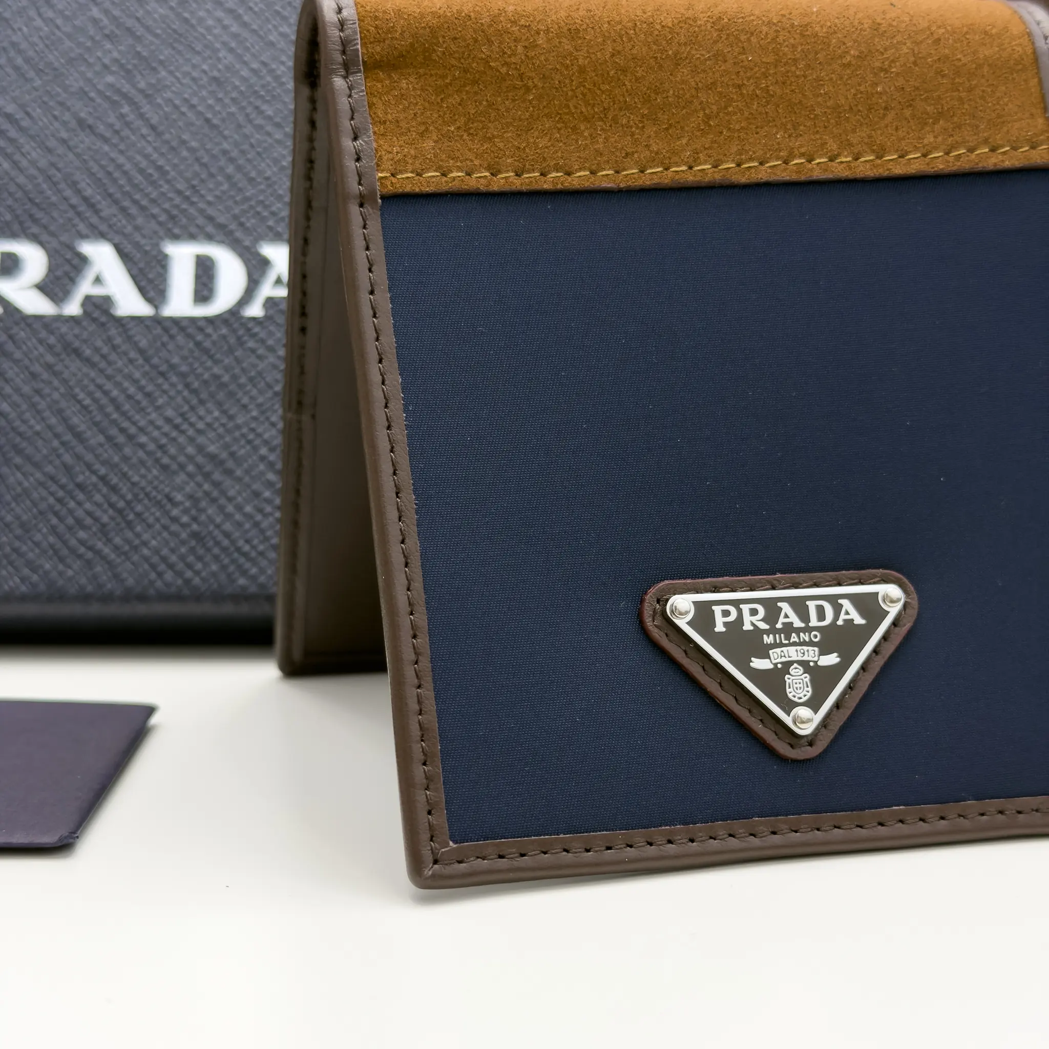 Prada navy Re-Nylon bifold wallet with brown suede detail and triangle logo