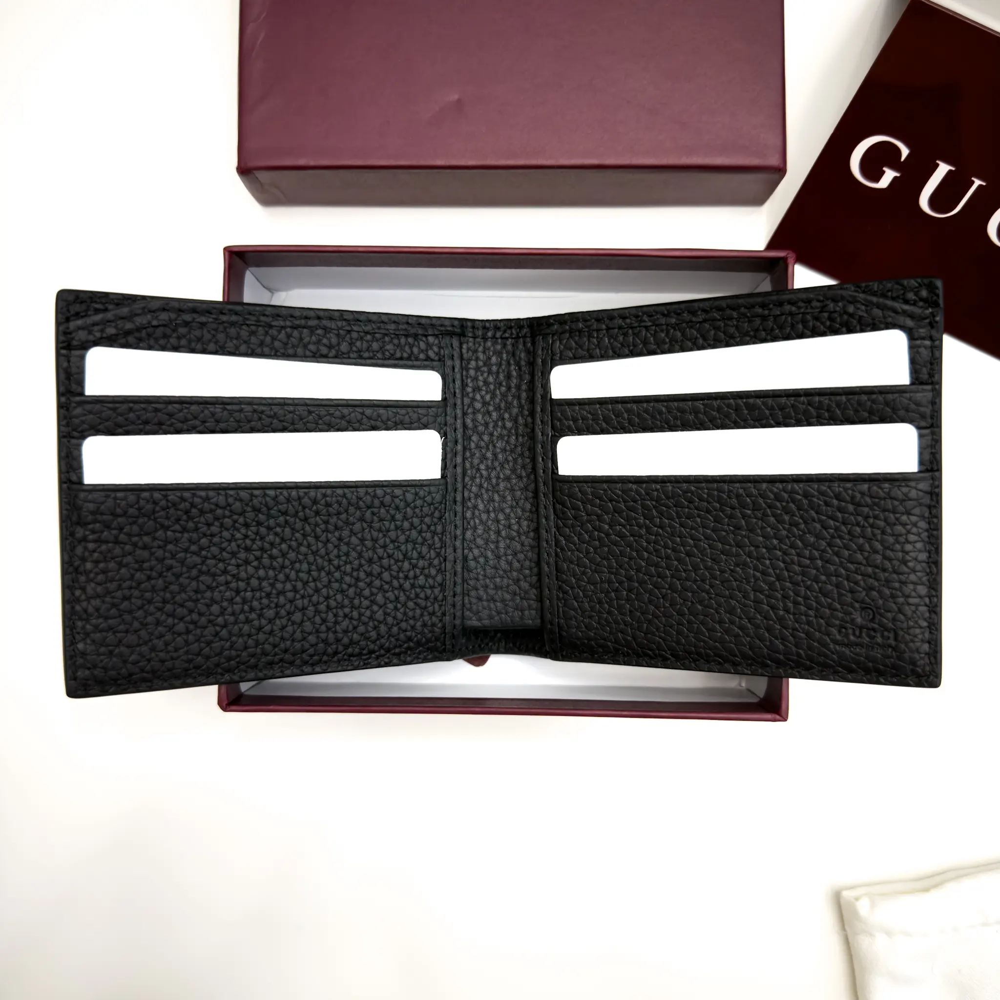 Gucci Jumbo GG black grained leather bifold wallet with oversized tonal GG motif