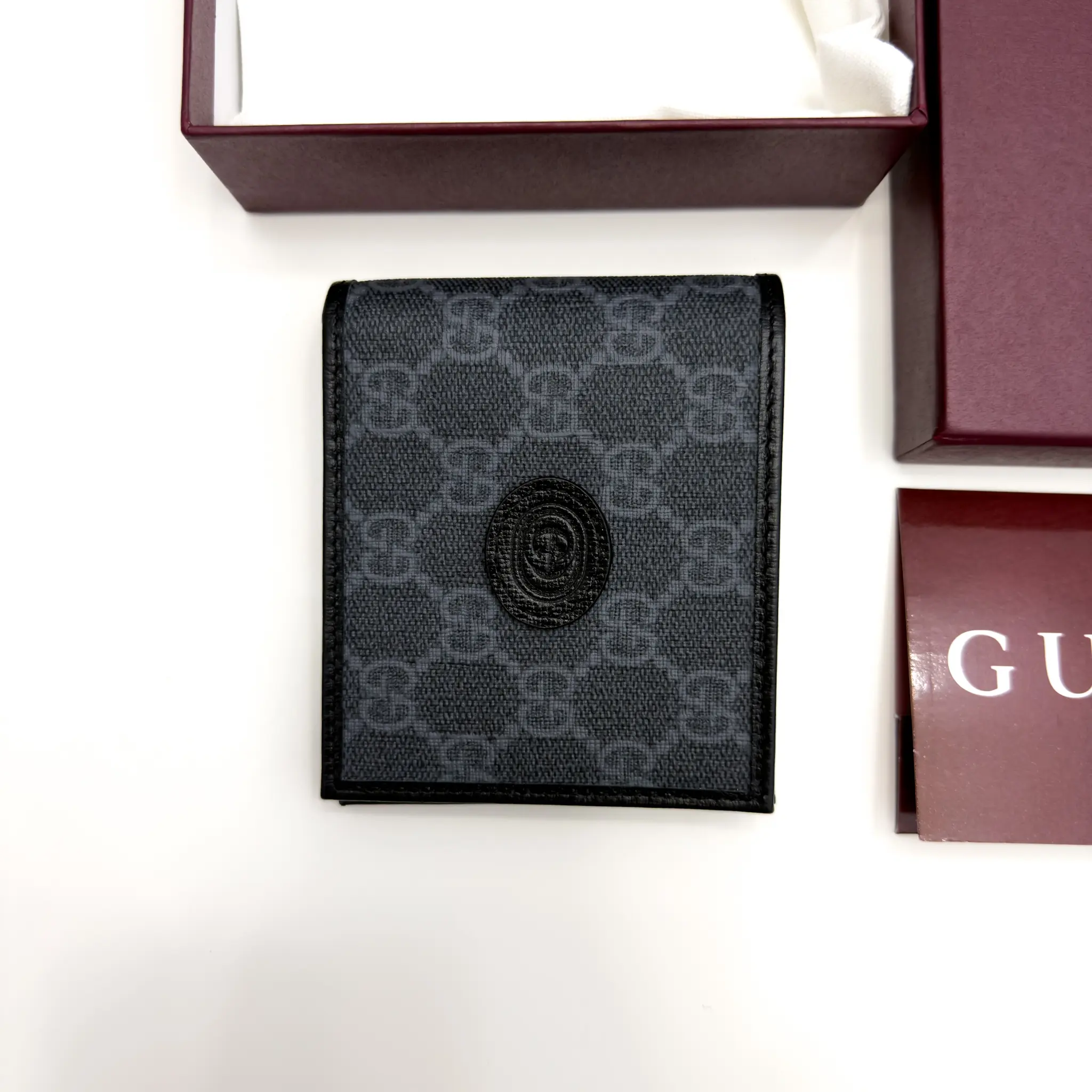 Gucci Interlocking G black and grey GG Supreme bifold wallet with black leather trim