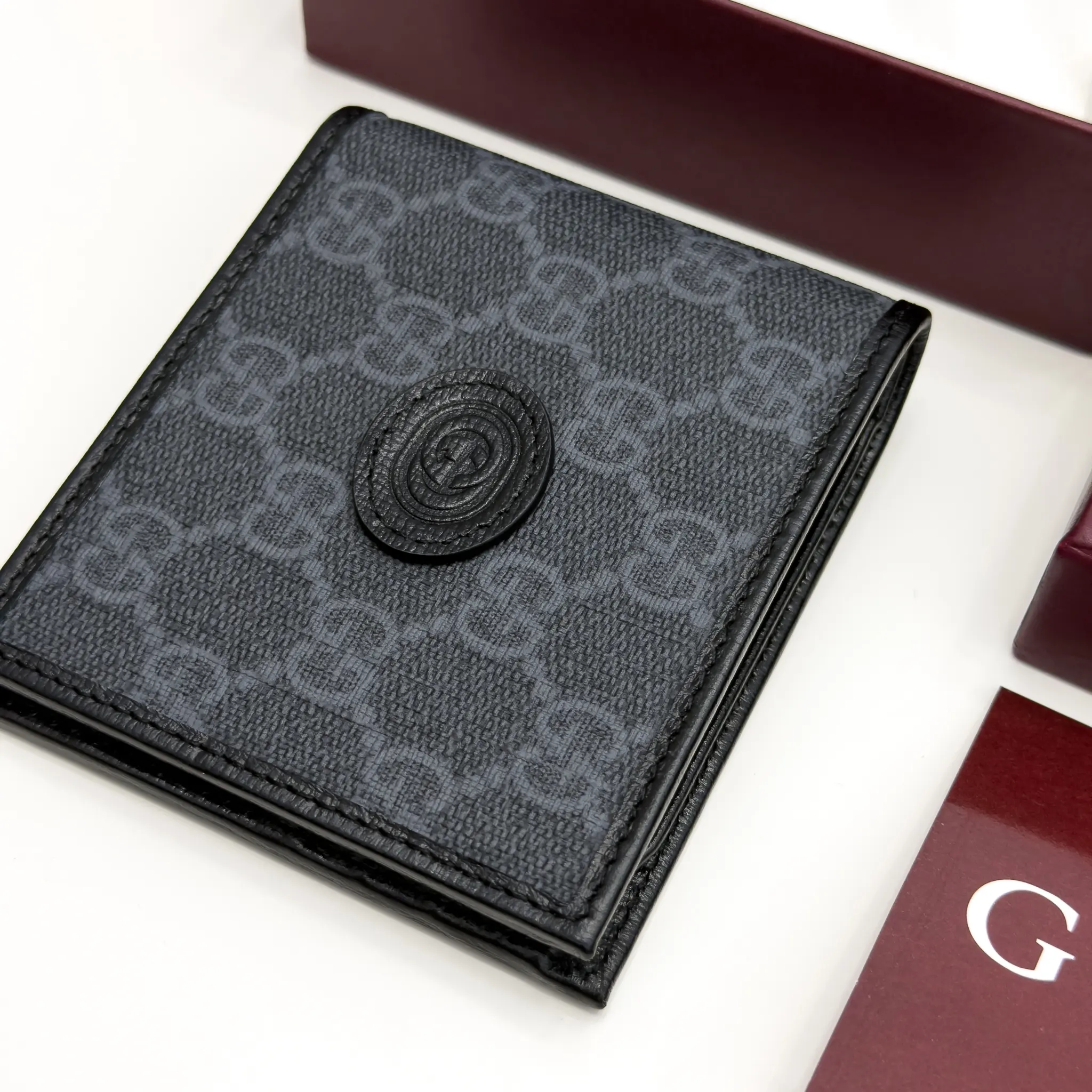 Gucci Interlocking G black and grey GG Supreme bifold wallet with black leather trim