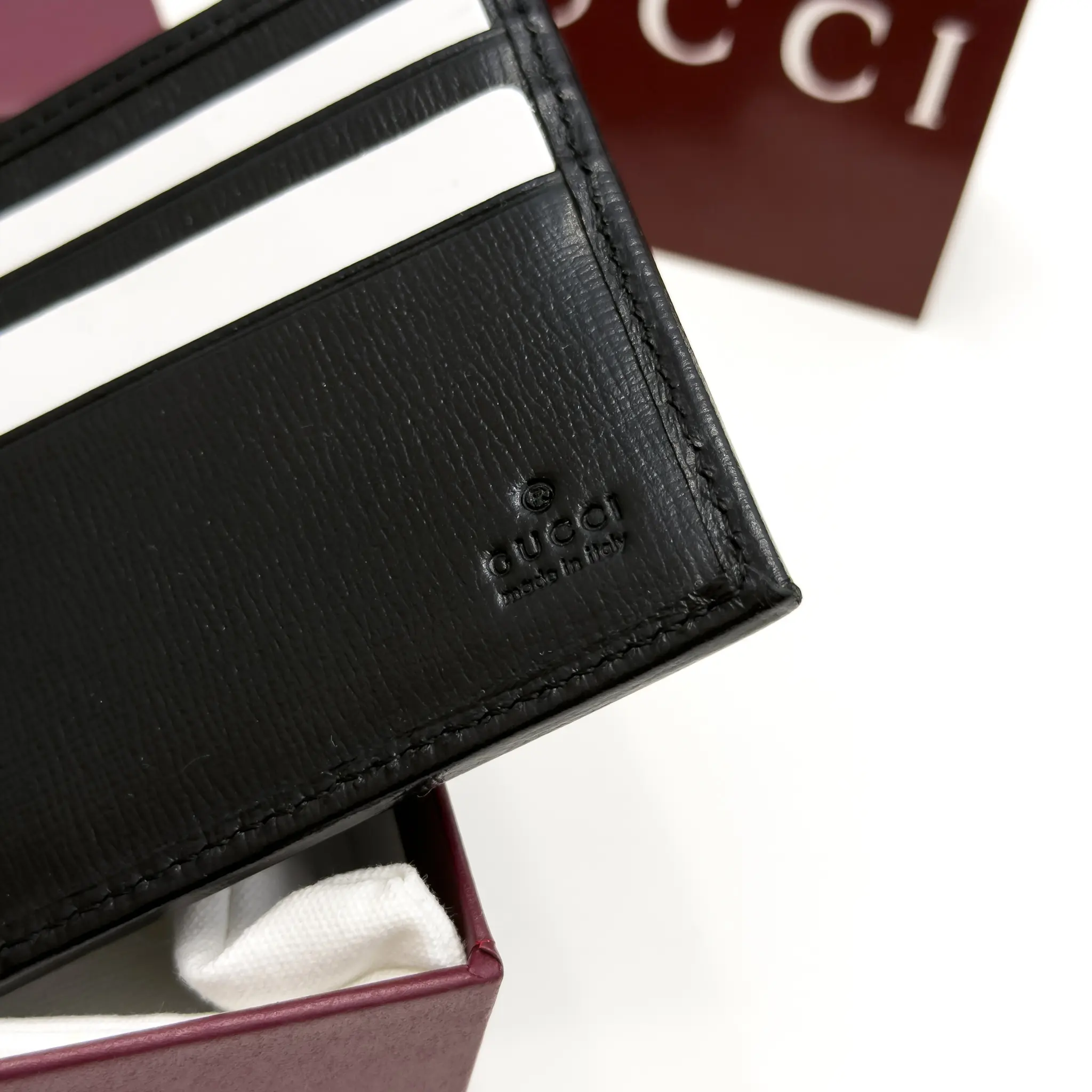 Gucci Interlocking G black and grey GG Supreme bifold wallet with black leather trim