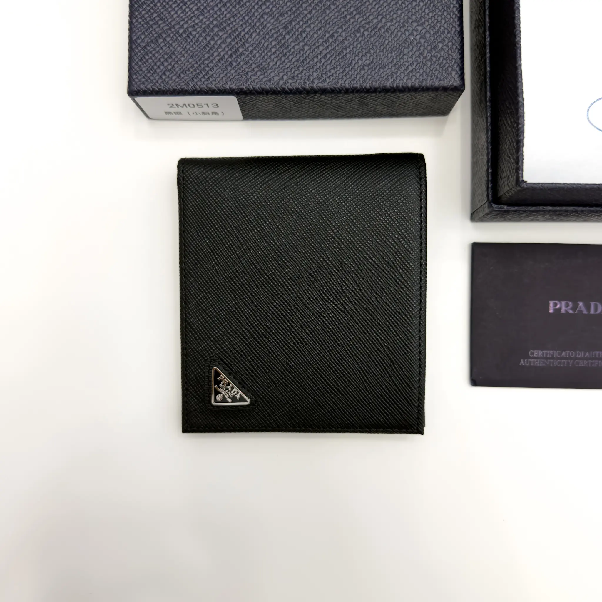 Prada black Saffiano leather bifold wallet with enameled triangle logo