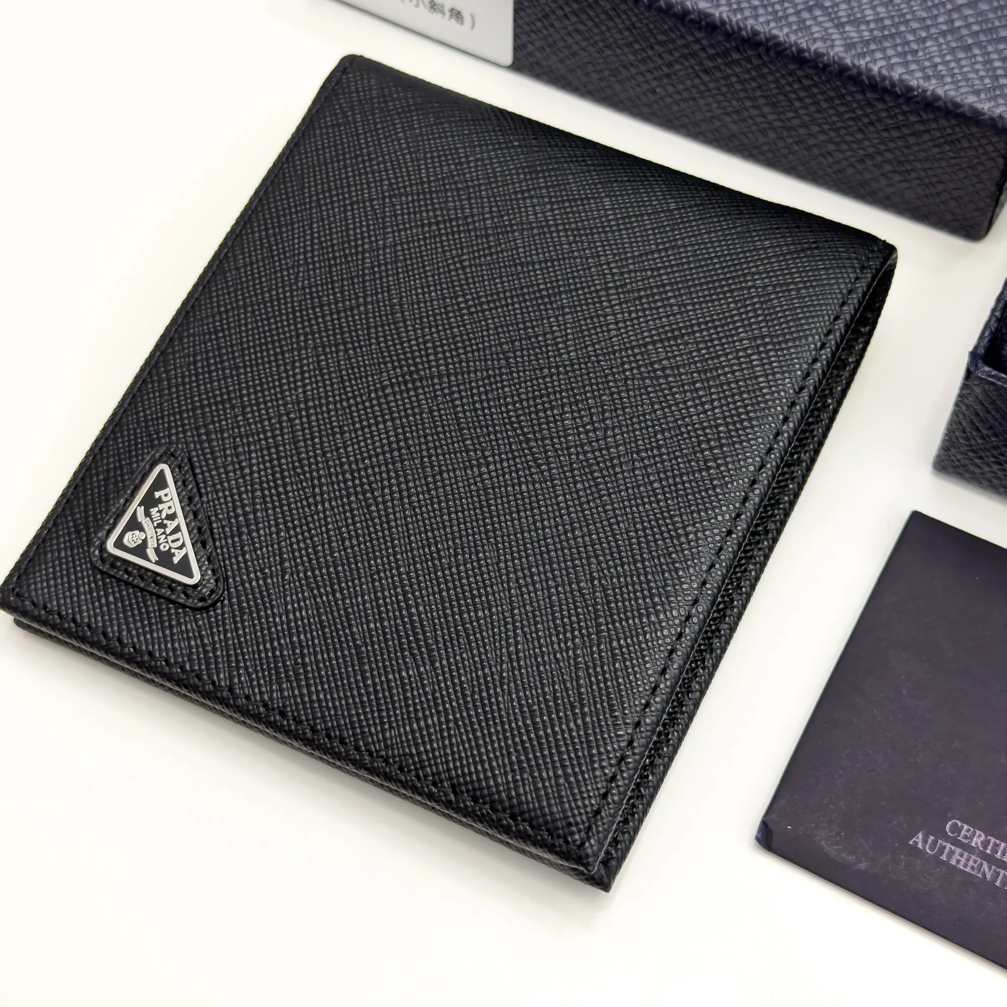 Prada black Saffiano leather bifold wallet with enameled triangle logo