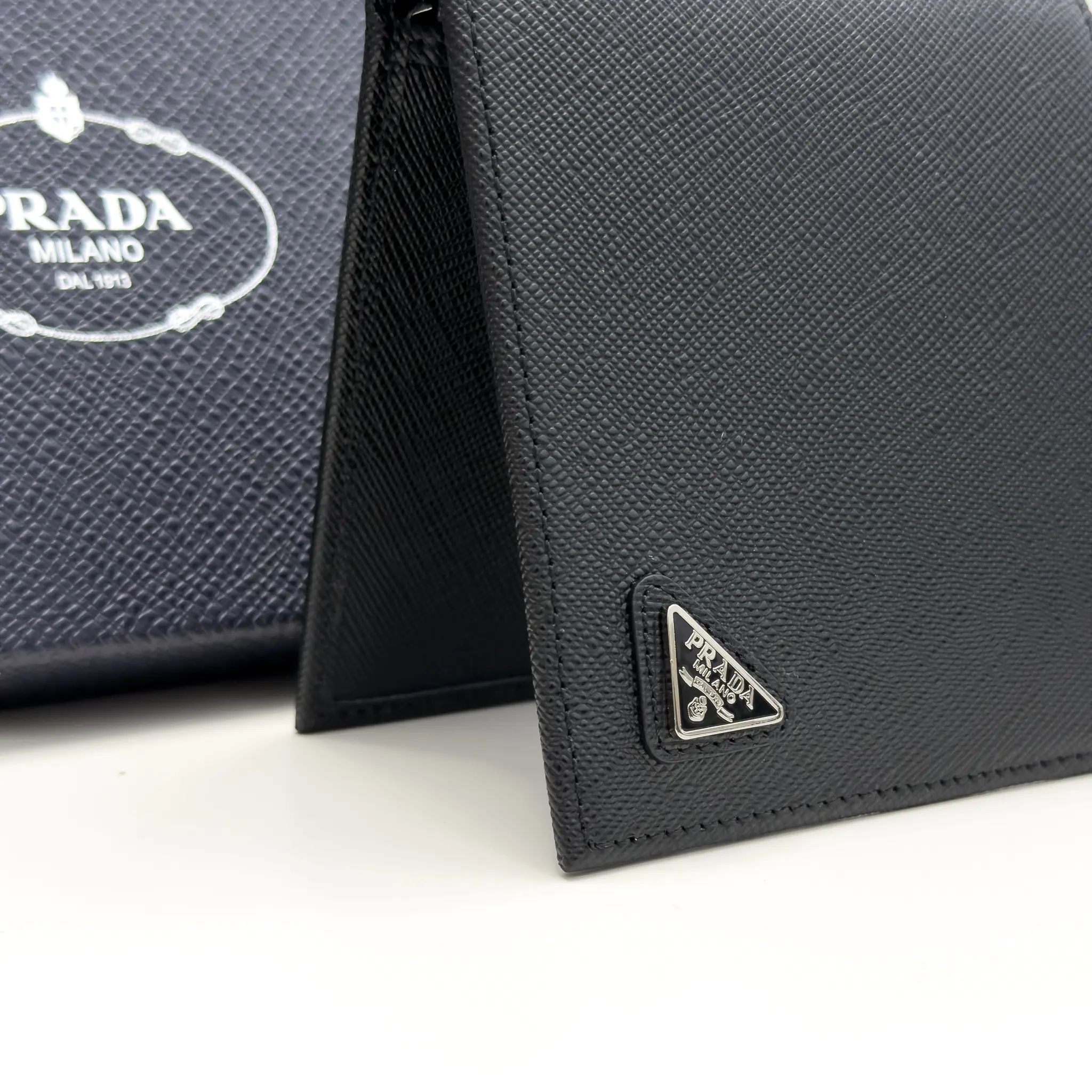 Prada black Saffiano leather bifold wallet with enameled triangle logo