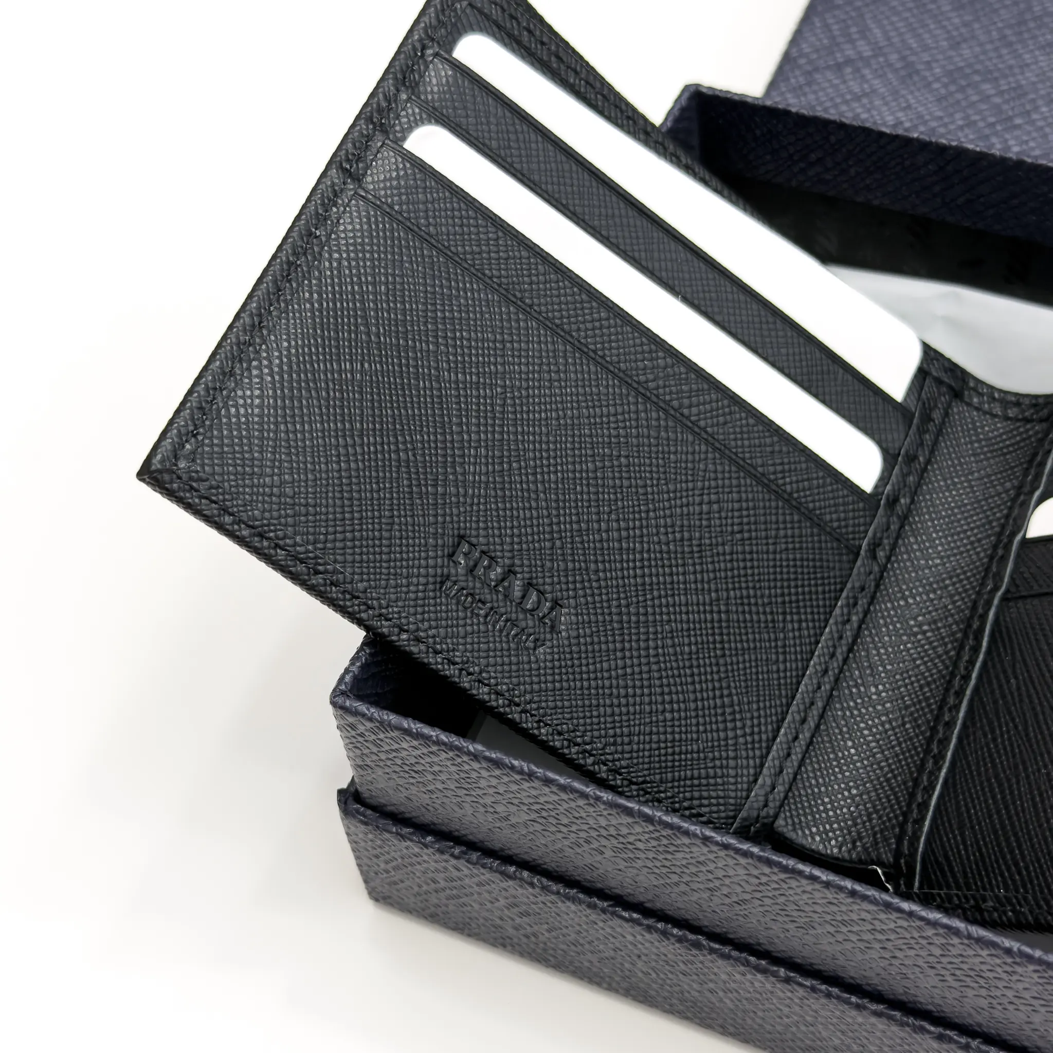 Prada black Saffiano leather bifold wallet with enameled triangle logo