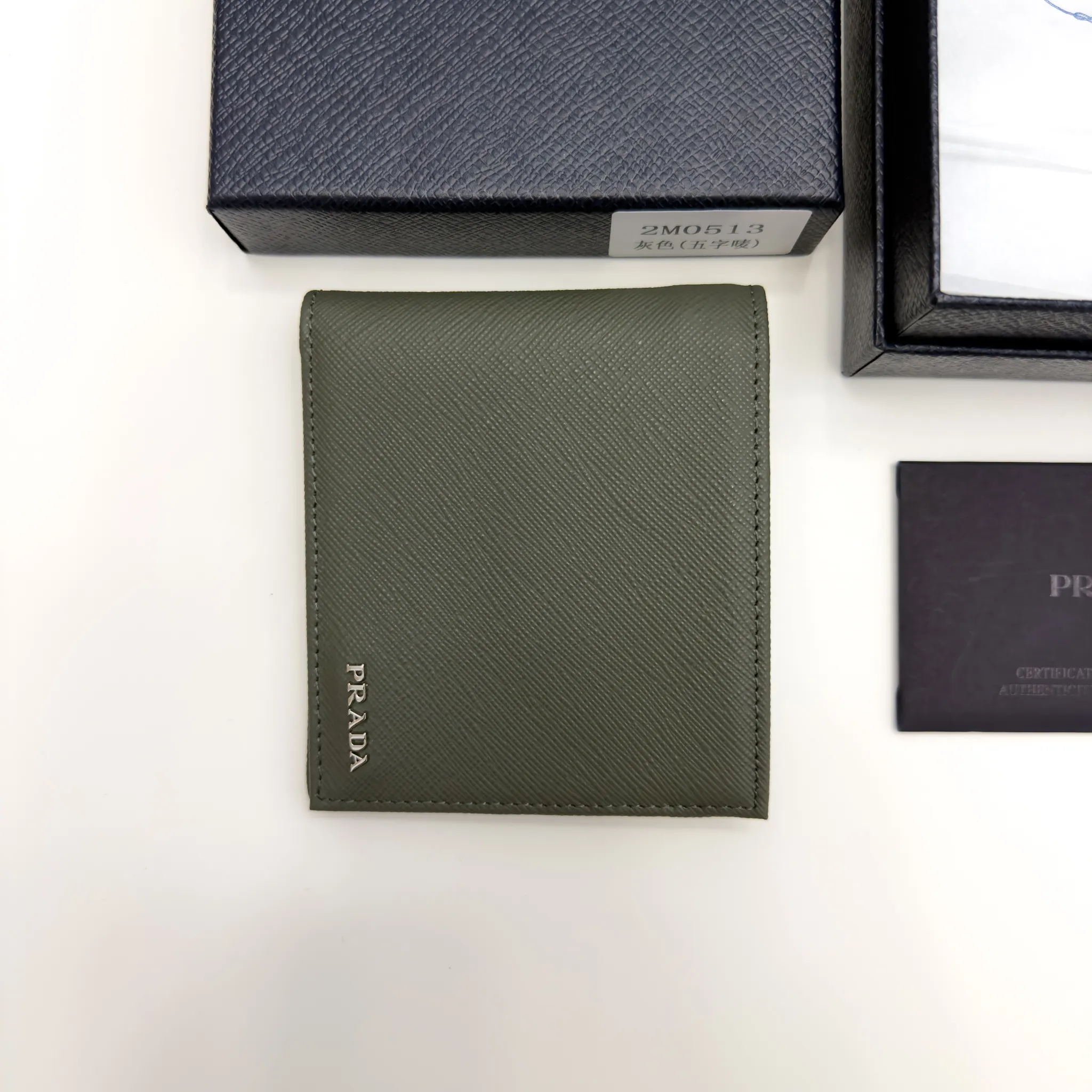 Prada Selva Green Saffiano leather bifold wallet with metal lettering logo