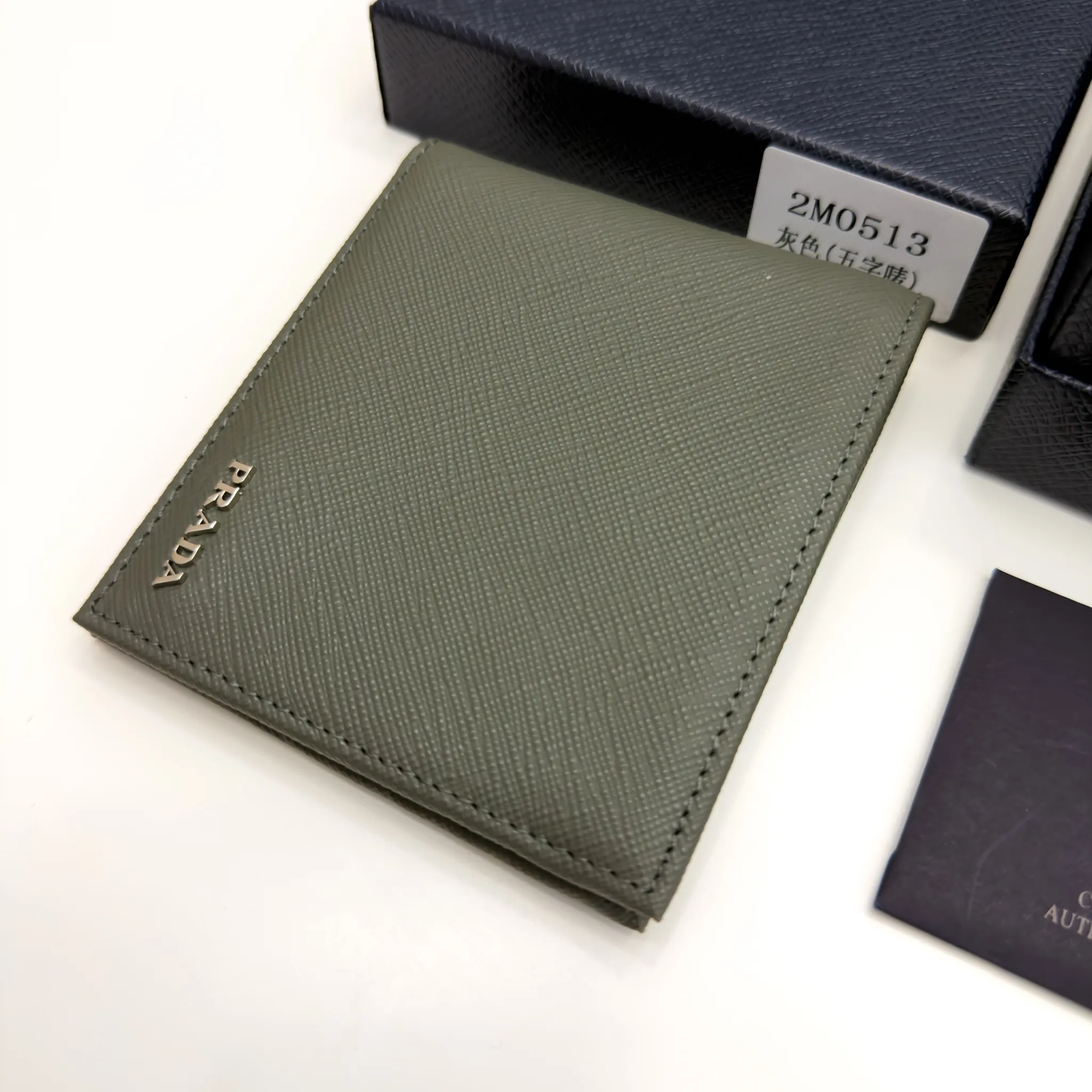 Prada Selva Green Saffiano leather bifold wallet with metal lettering logo