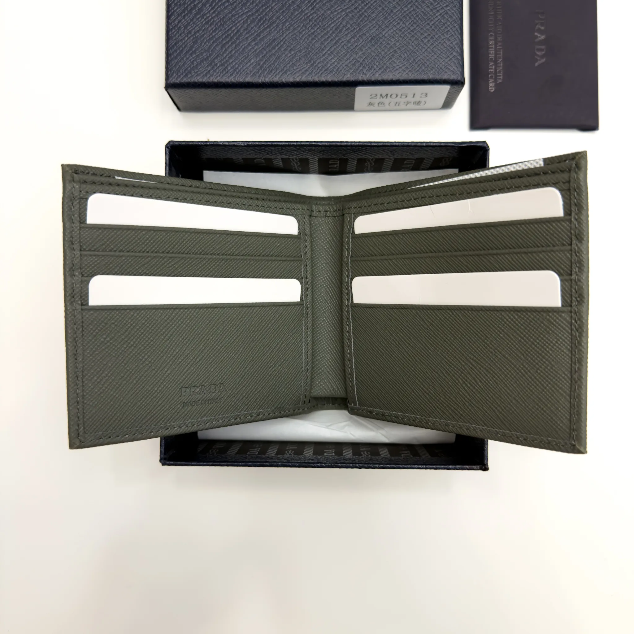 Prada Selva Green Saffiano leather bifold wallet with metal lettering logo