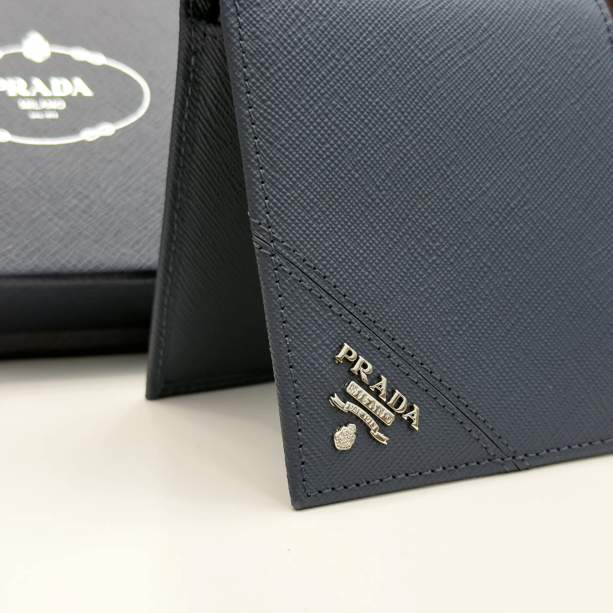Prada Baltic Blue Saffiano leather bifold wallet with intarsia corner detail and metal logo