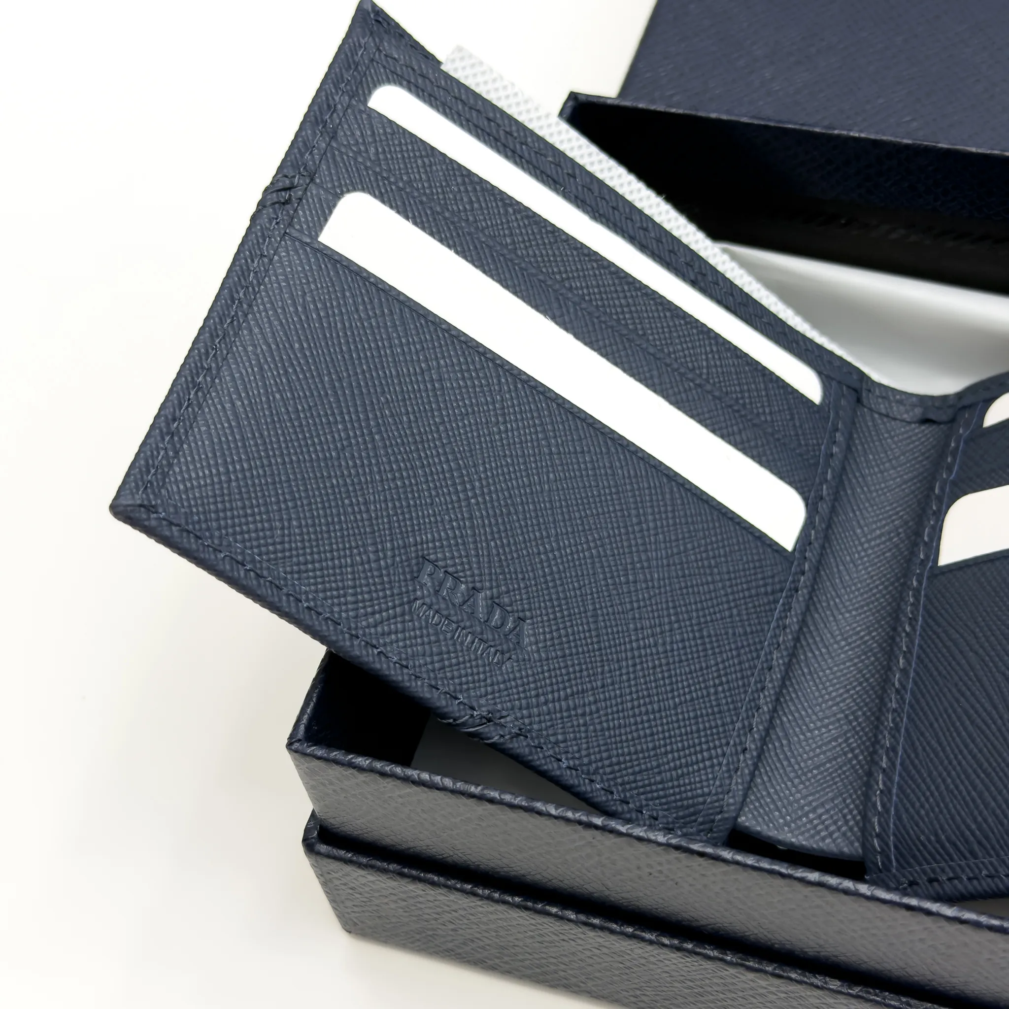 Prada Baltic Blue Saffiano leather bifold wallet with intarsia corner detail and metal logo